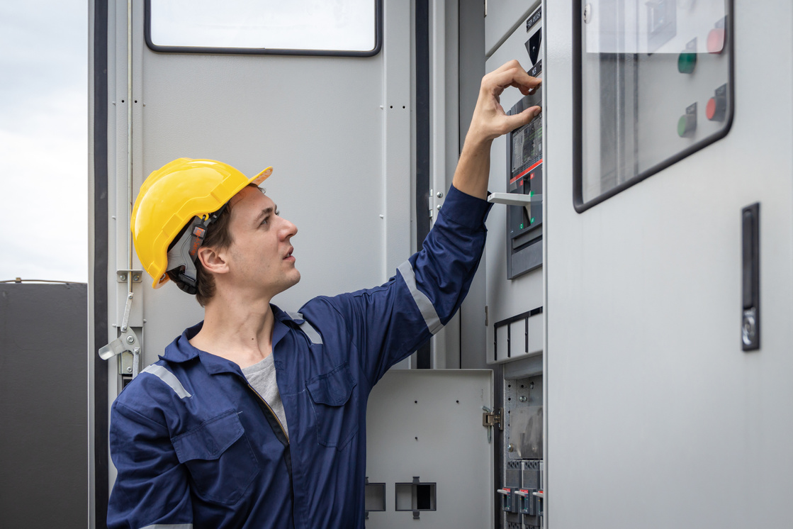 Electrical engineer working in control room. Electrical engineer